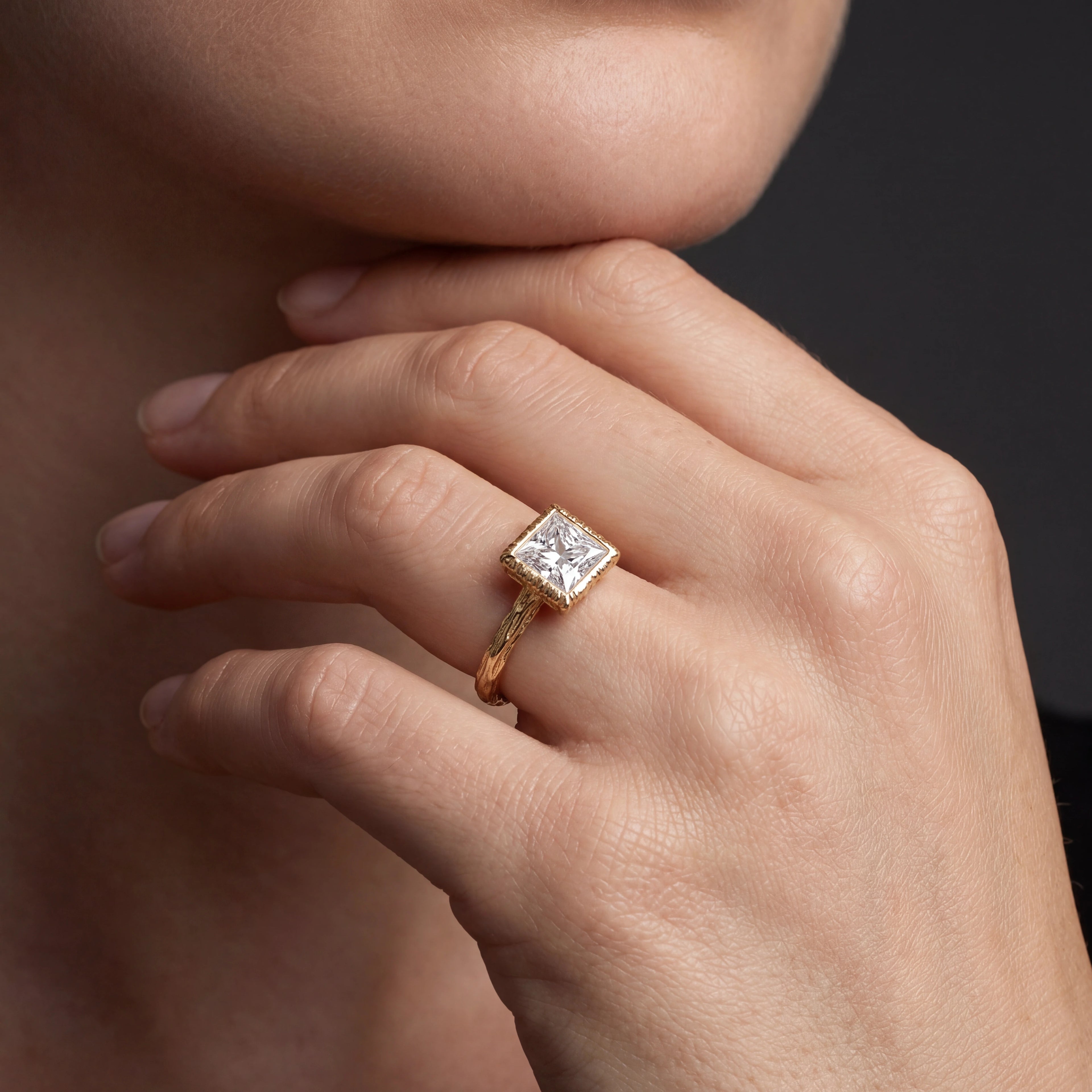 Princess cut Lab-Grown Diamond engagement ring with hand-carved branch band in 14K rose gold, worn on hand