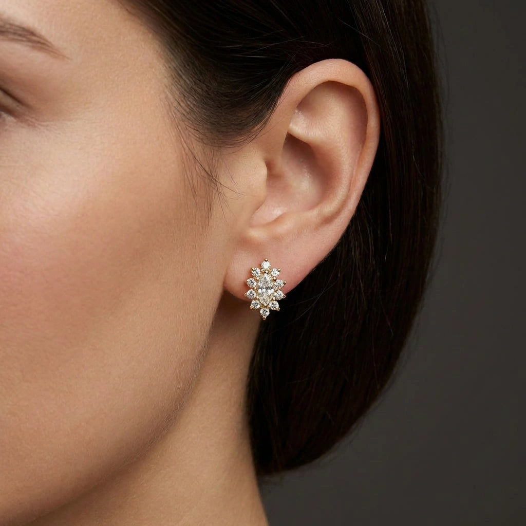 Close-up view of Queens Crown marquise diamond stud earrings on ear with floral halo setting