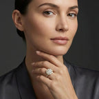 Woman wearing round diamond halo engagement ring with pavé band - elegant portrait lifestyle photo
