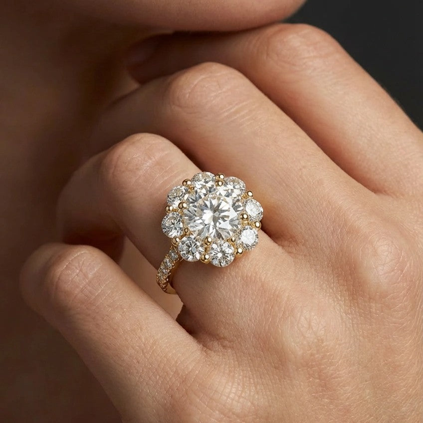 Round diamond halo engagement ring with pavé band on hand - showing brilliant sparkle and halo detail