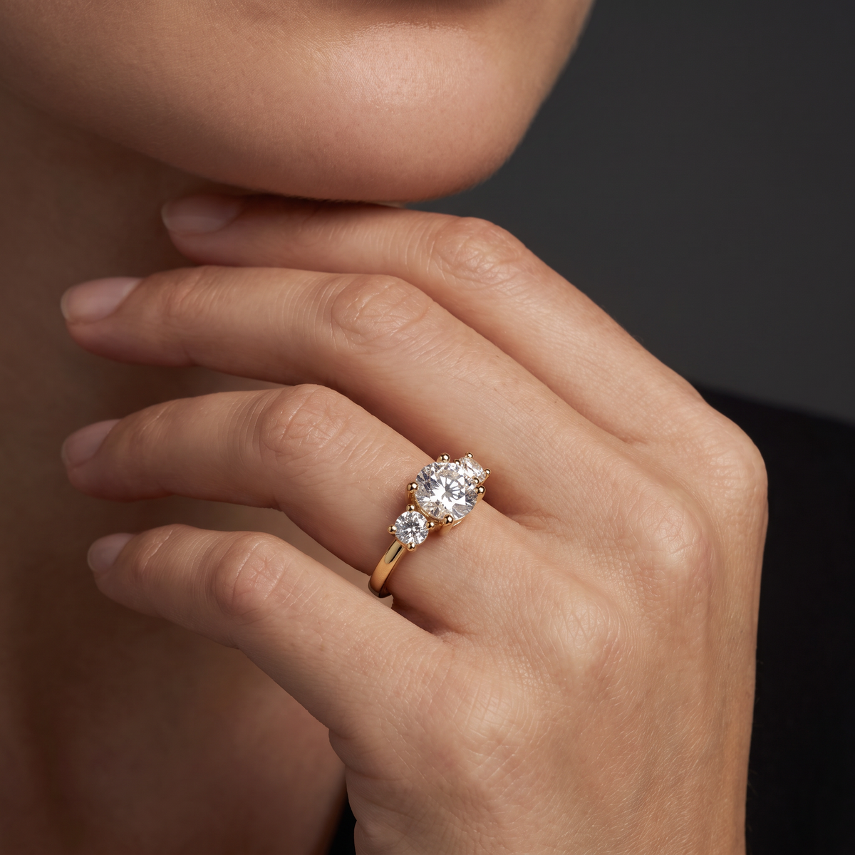 1ct round three-stone engagement ring in 14K yellow gold worn on hand, three round Lab-Grown Diamonds across the finger