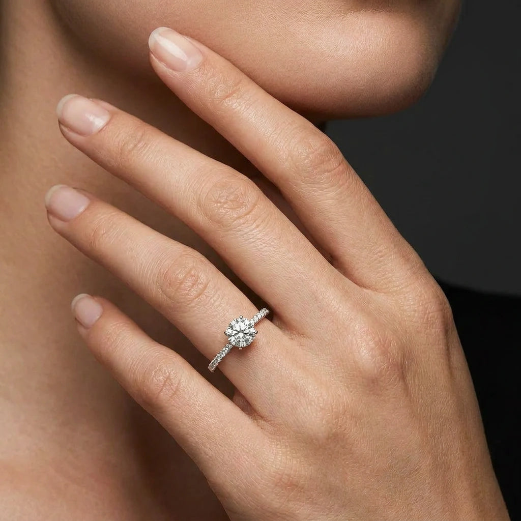 Woman wearing a round ultra thin pavé engagement ring with lab-grown diamond