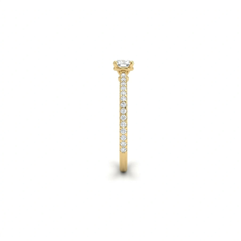 Side profile of round ultra thin pavé engagement ring in solid 14K yellow gold