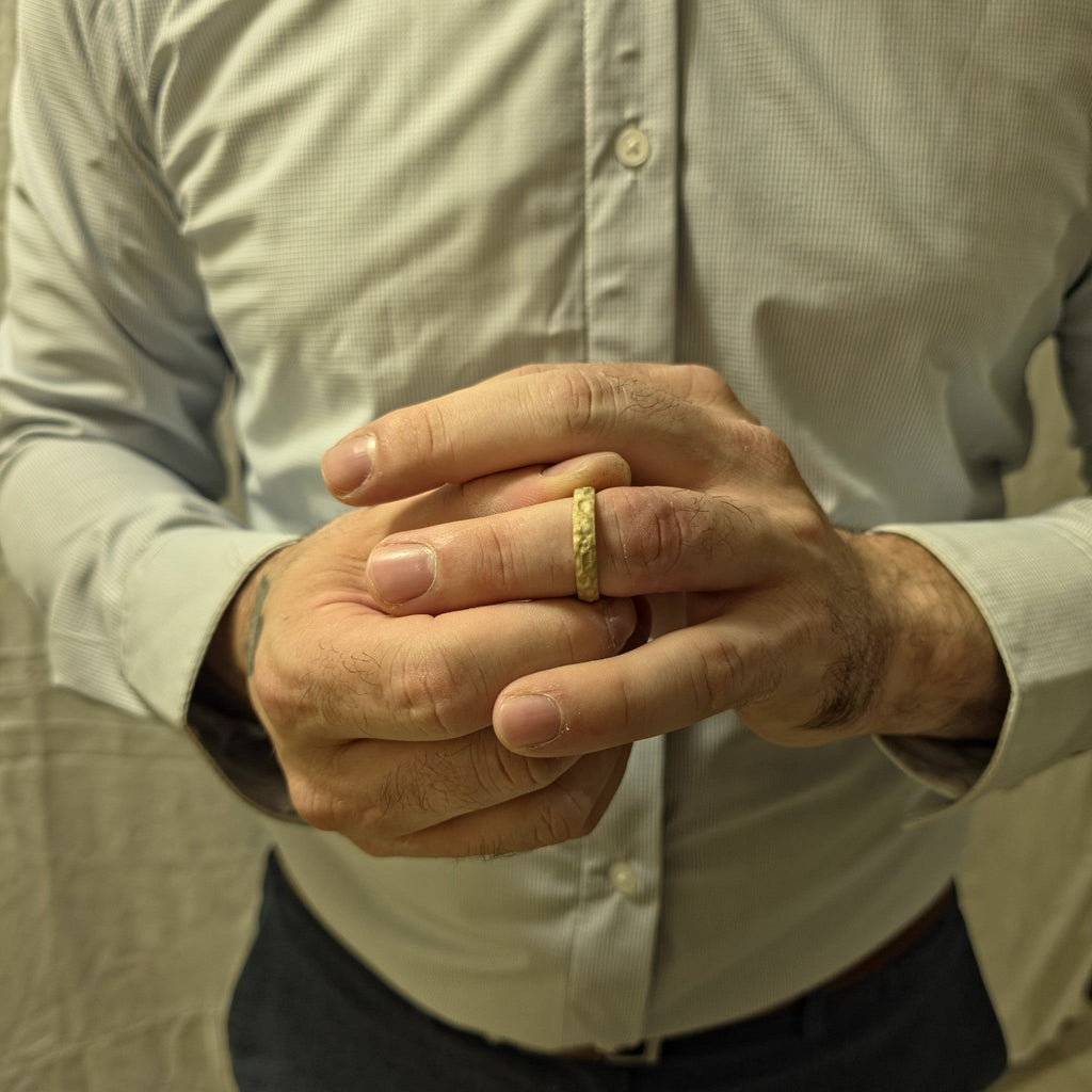 Rustic Gold Ring textured hammered design in 14K gold on man’s finger