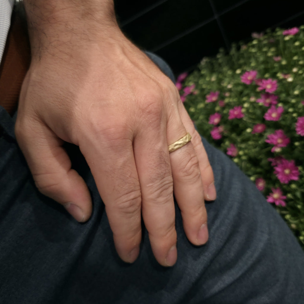 Rustic Gold Ring hammered gold band shown on man’s hand