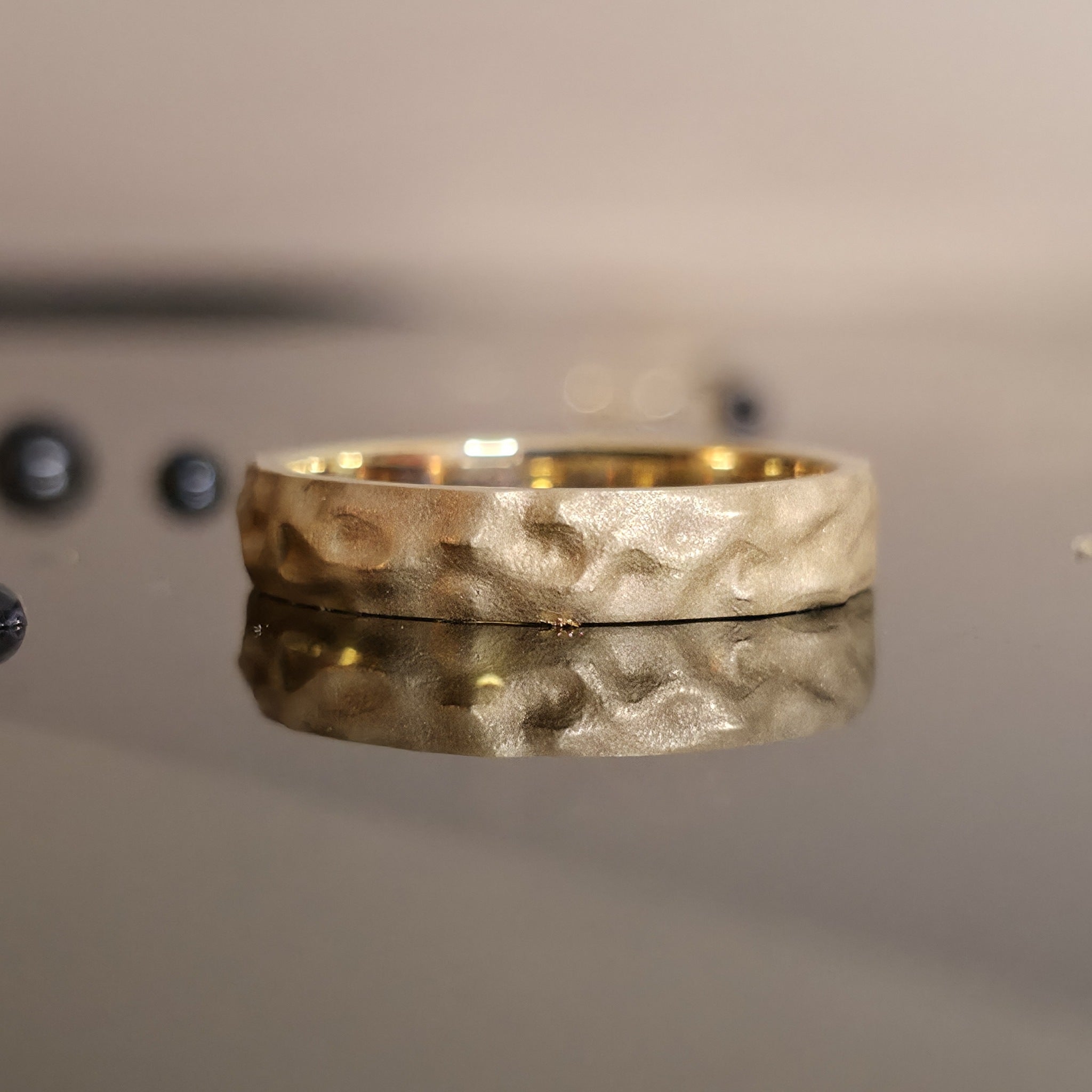 Rustic Gold Ring with hammered texture in 14K yellow gold on mirror background