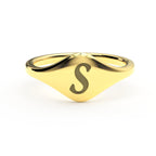 S initial cursive signet ring front view ofthe ring in polished 14K gold on a soft beige background