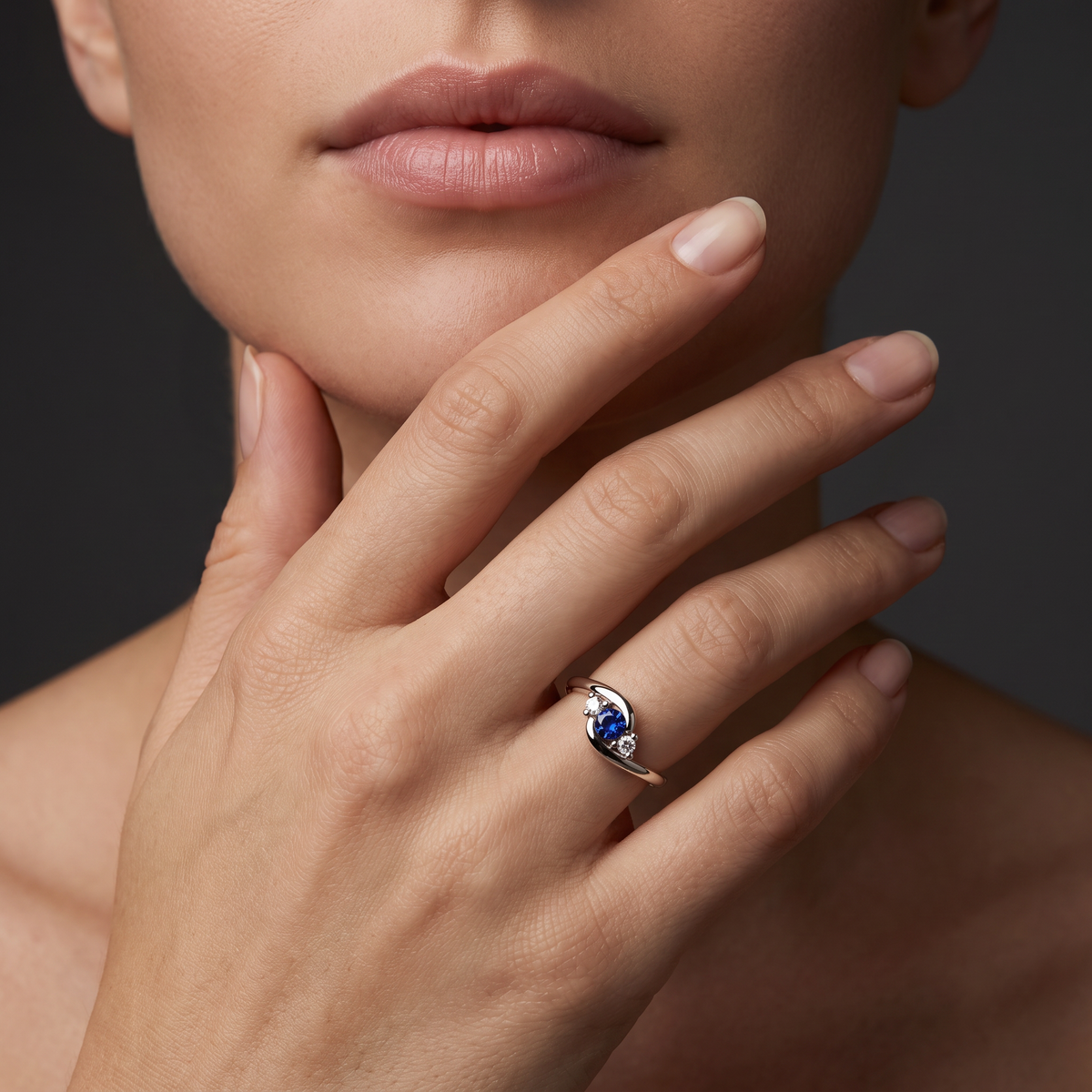 Lab-Created Blue Sapphire three-stone bypass ring in 14K white gold worn on the hand