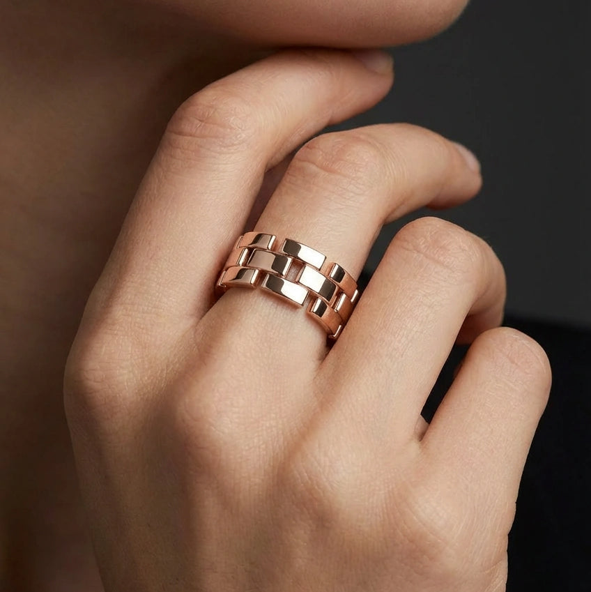 Woman wearing Stratum Link Band in rose gold, showcasing bold interlocking link ring with architectural design