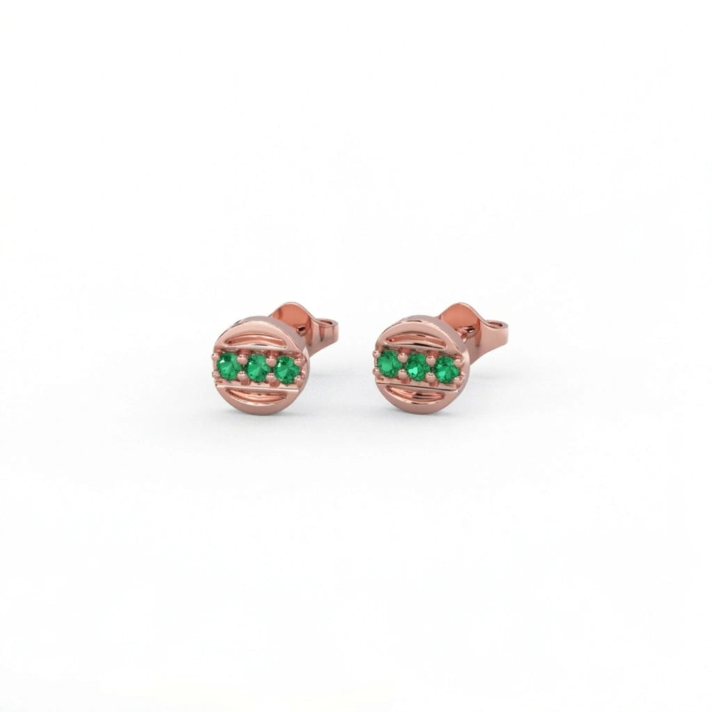 Tauren emerald line stud earrings in 14k rose gold with horizontal emerald gemstones in sleek circular setting