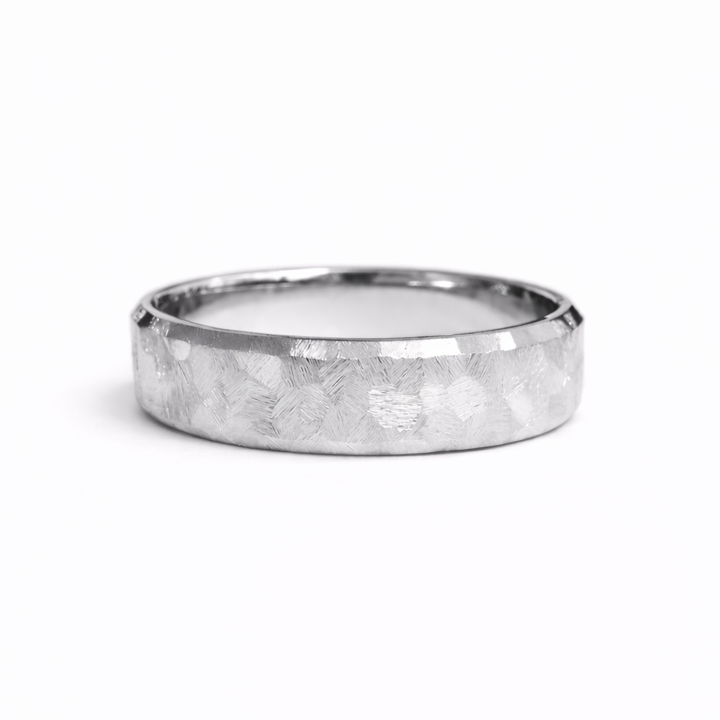 Textured white gold wedding band with hand-worked faceted surface