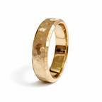 Handcrafted textured 14K yellow gold wedding band with faceted finish