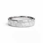 Textured platinum wedding band with hand-worked faceted surface