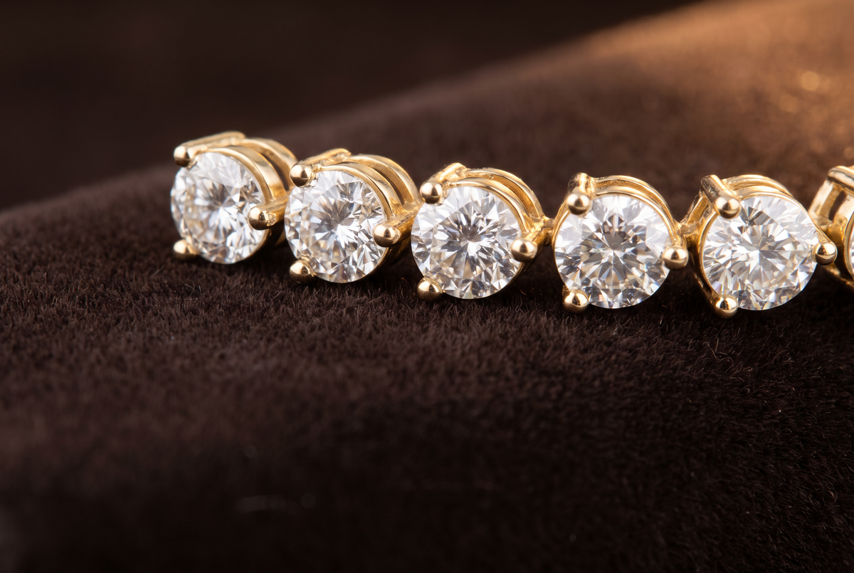 Three-prong lab-grown diamond tennis bracelet in 14K yellow gold, close-up of the prong setting