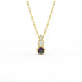 Tria Aura Diamond and Alexandrite Necklace in 14K yellow gold with three stone bezel design and alexandrite center