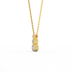 Tria Bezel Diamond Necklace in 14K yellow gold side view showing three bezel set round diamonds