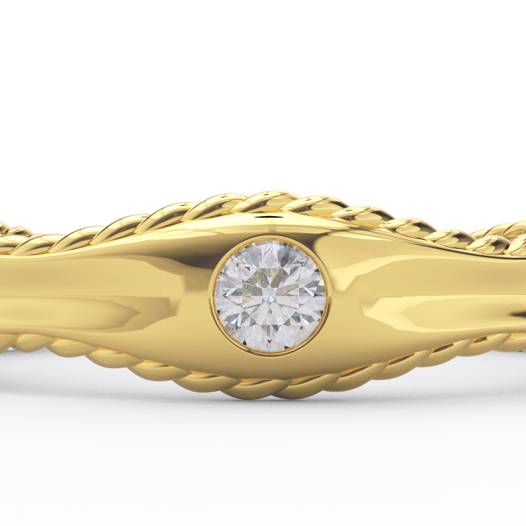 Close-up of flush set round diamond in 14K yellow gold wave band with twisted rope edges
