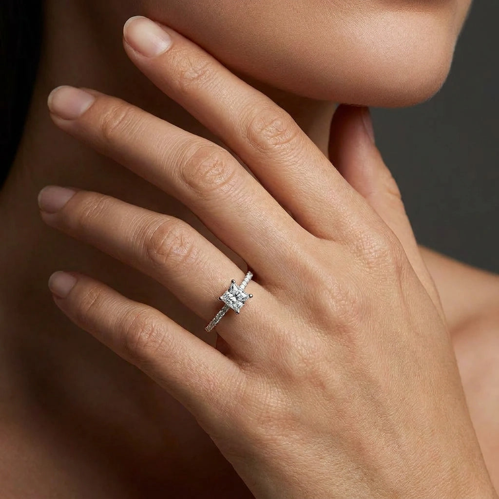 Woman wearing an ultra thin princess cut pavé diamond engagement ring