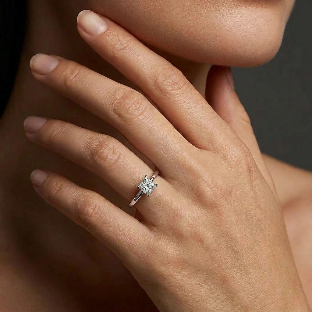 Woman wearing an ultra thin princess cut solitaire engagement ring