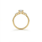 Valen emerald diamond ring side profile showing elevated emerald cut center setting and diamond side stones