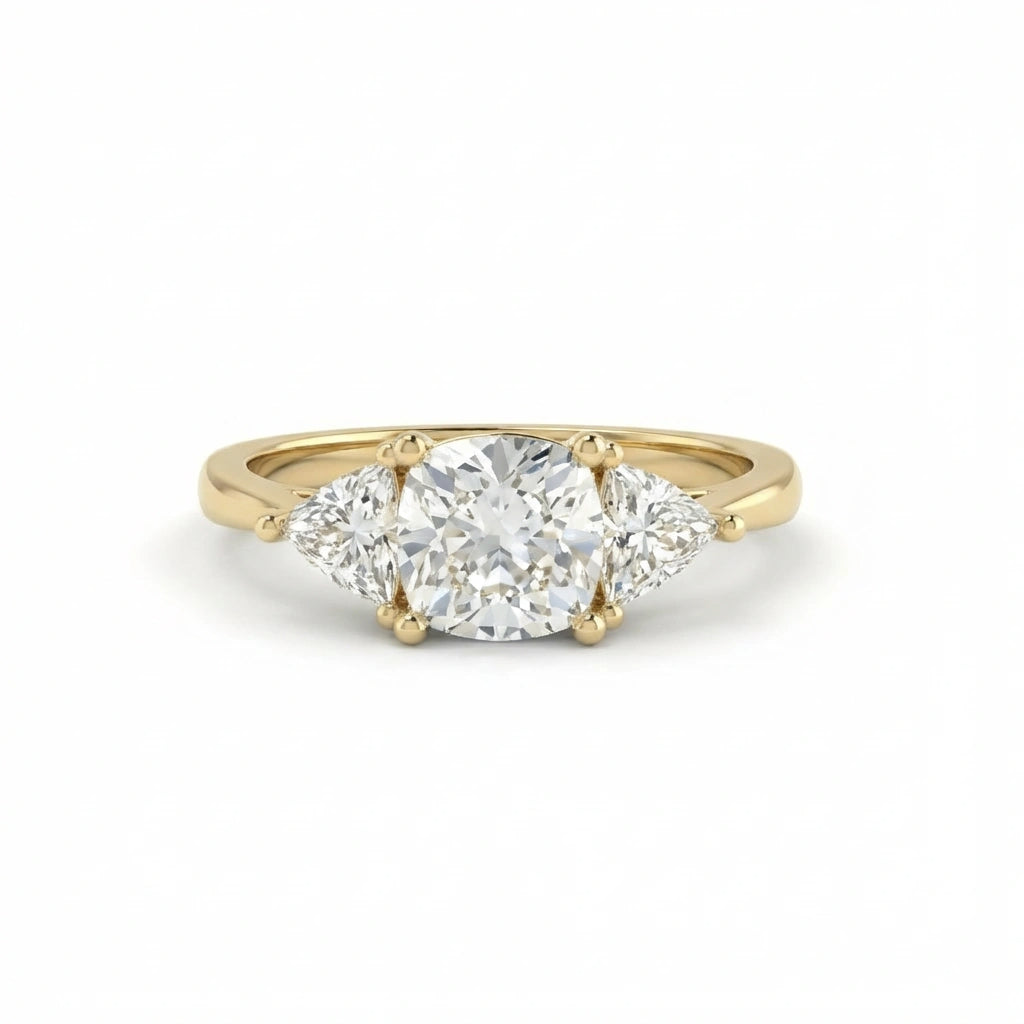 Vela trilogy diamond engagement ring in 14k yellow gold with round center diamond and pear side stones, classic three stone ring
