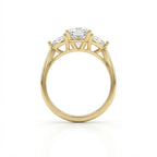Vela trilogy diamond engagement ring side view in 14k yellow gold with round center diamond and pear side stones, cathedral setting