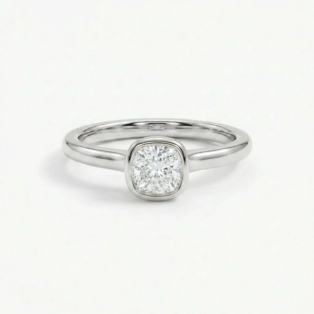 Solid 14K white gold cushion cut diamond ring with bezel setting and minimal polished band