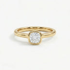 Solid 14K yellow gold cushion cut diamond ring with bezel set center stone and sleek band