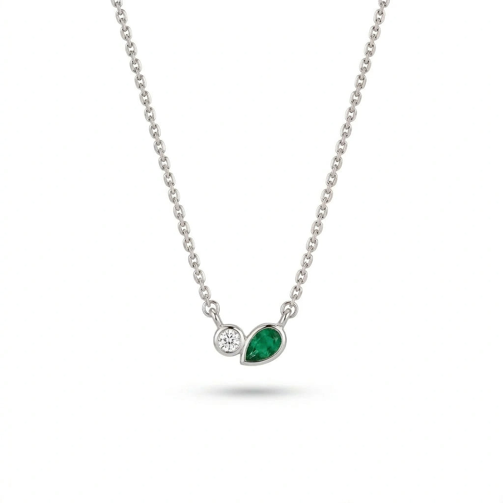 Bezel set diamond and pear emerald necklace in 14k white gold