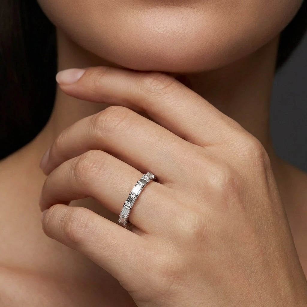 Female model wearing Virel Baguette Cut Diamond Band in 14K white gold, close-up editorial portrait shot showing 7 baguette diamonds on slim 1.8mm stacking band on finger