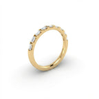 Virel Baguette Diamond Half Eternity Band in 14K yellow gold, angled side view showing profile of slim band with horizontal bar-set baguette diamonds and plain gold shank
