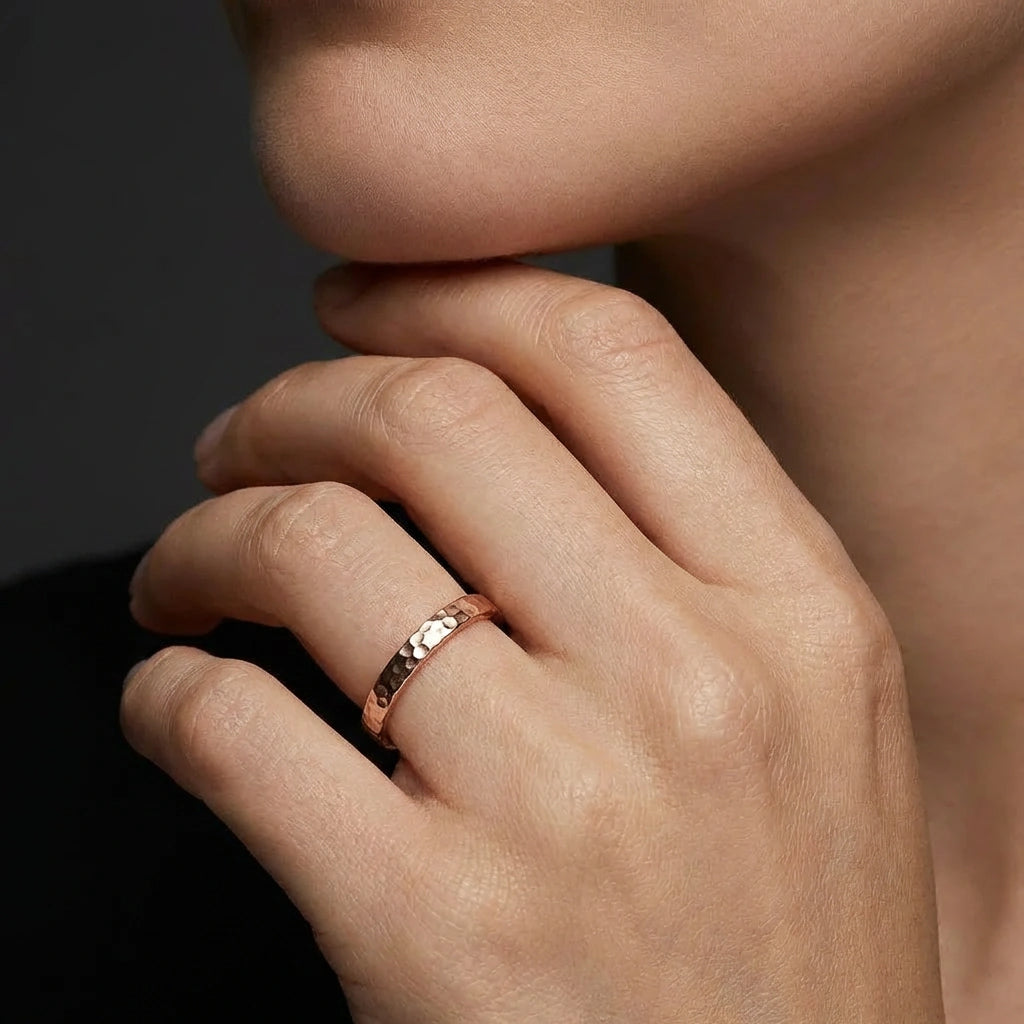 Model wearing Virel hammered gold band in solid rose gold with handcrafted texture and minimalist style