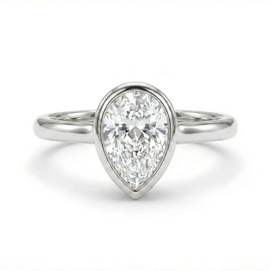Solid 14K white gold pear cut diamond ring with smooth bezel setting and minimalist band