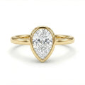 Solid 14K yellow gold pear cut diamond ring with bezel setting and polished slim band