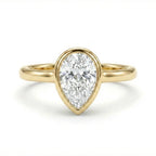 Solid 14K yellow gold pear cut diamond ring with bezel setting and polished slim band