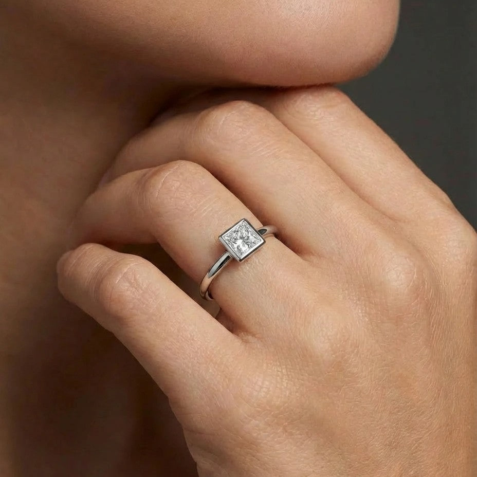 Model wearing Virex princess bezel diamond ring in solid gold with clean geometric design