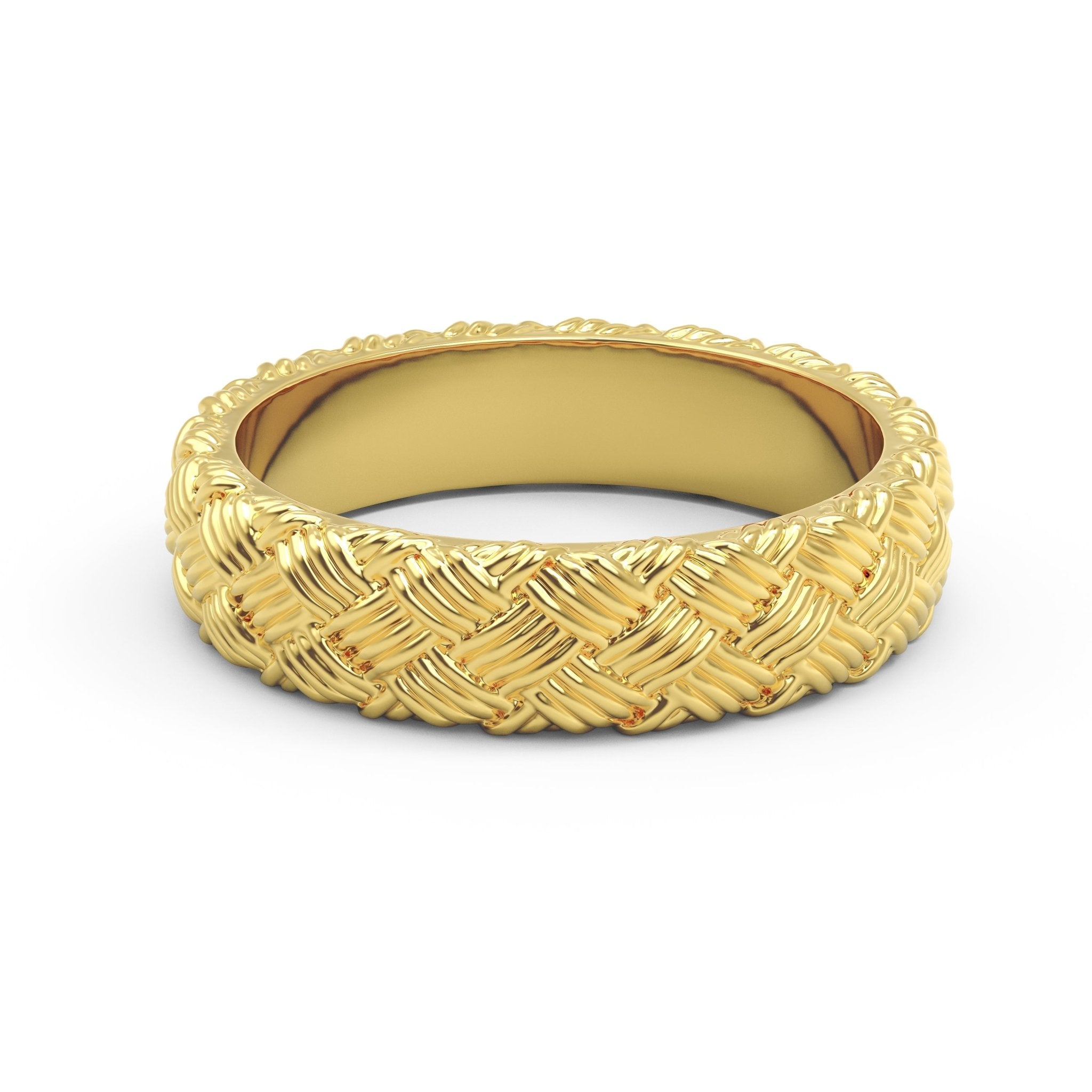 Close-up of woven gold ring with detailed basket weave texture on white surface