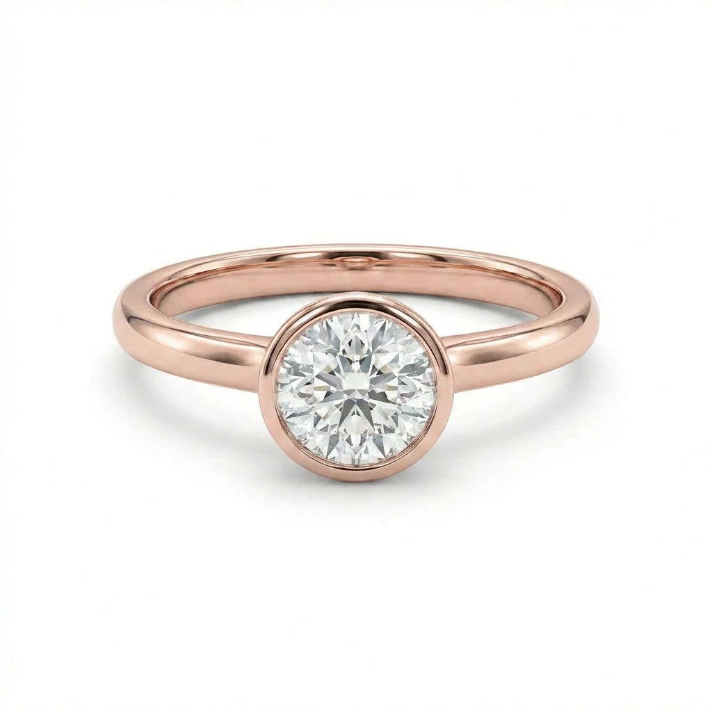 Zevar round cut diamond ring in solid 14K rose gold with smooth bezel setting and slim band