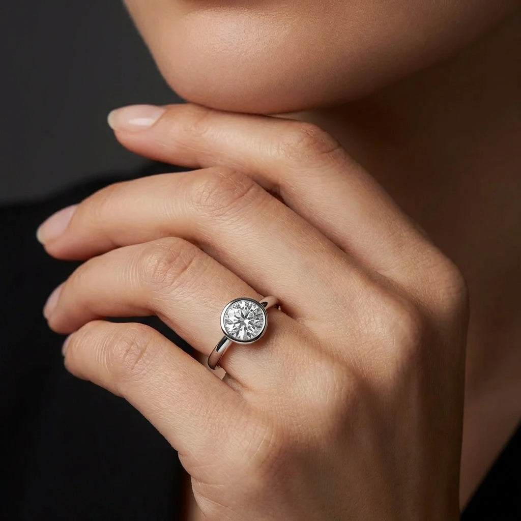 Model wearing Zevar round bezel diamond ring in solid gold with elegant minimalist design