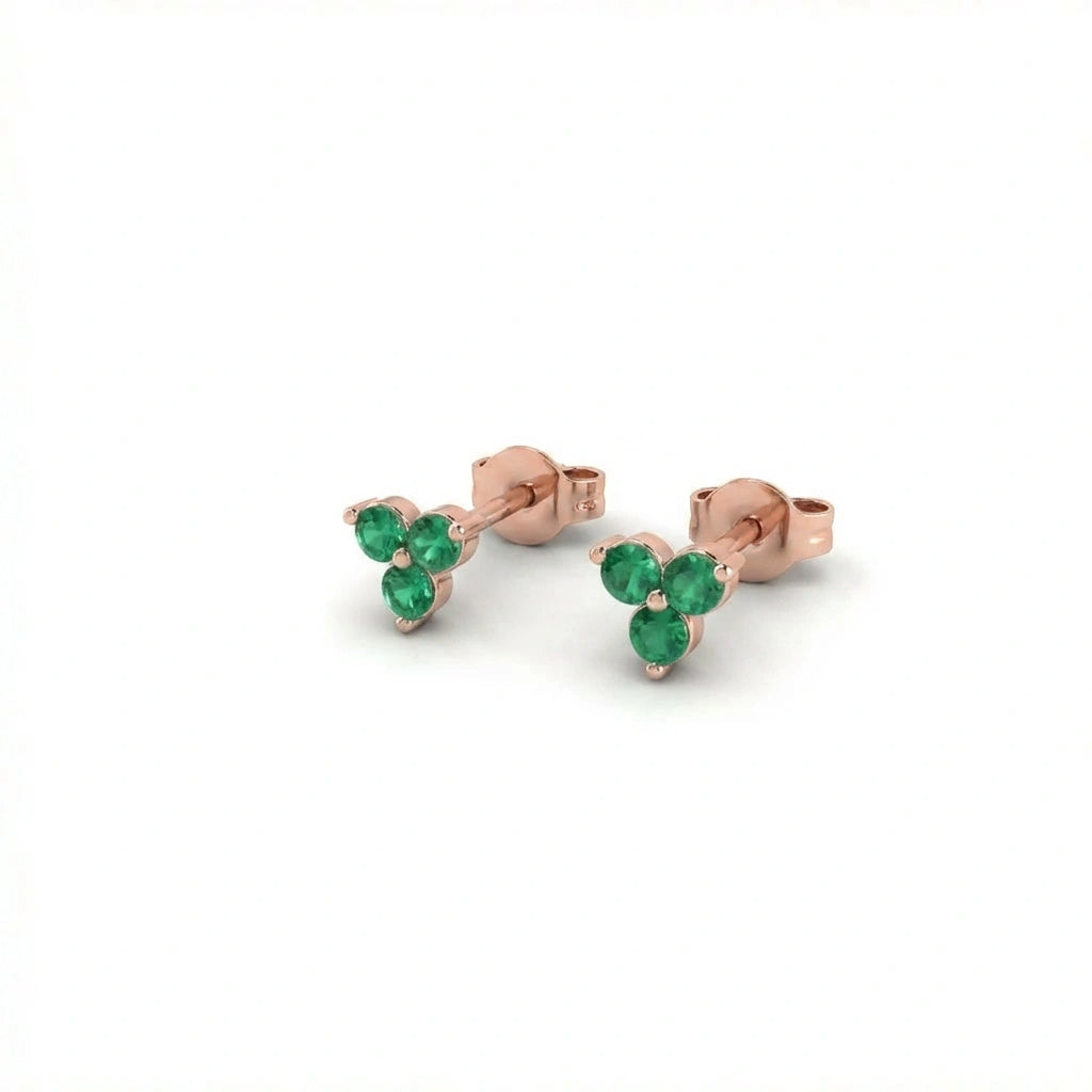 Zirelle emerald triad stud earrings in solid rose gold featuring three round green gemstones in cluster setting